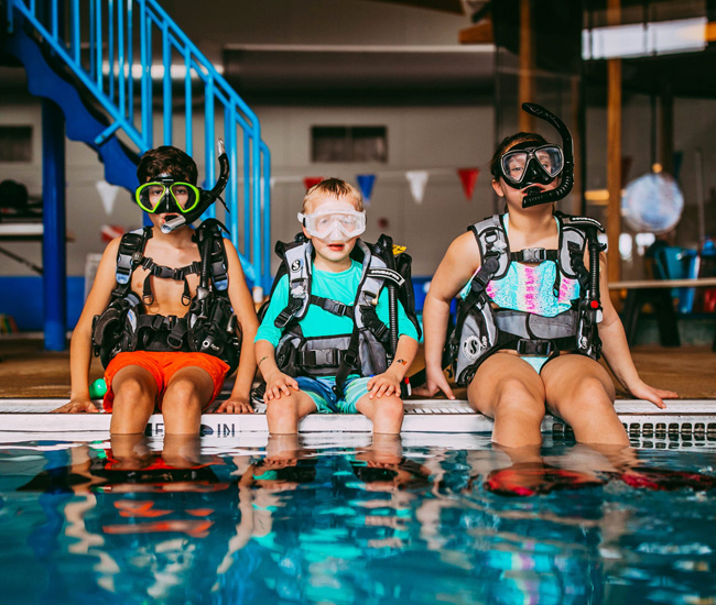 children getting ready for scuba diving course