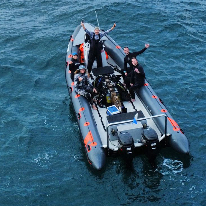 group photo of scuba divers on boat