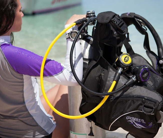 lady sitting with scuba diving equipment